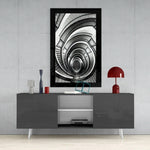 Spiral Stairs glass wall art styled above a sideboard in a stairwell