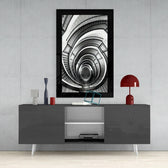 Spiral Stairs glass wall art styled above a sideboard in a stairwell