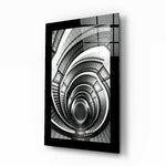 Spiral Stairs glass wall art displayed above a console in an entryway