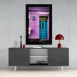 Colorful Building glass wall art styled above a sideboard in a reading nook