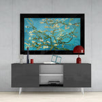 Turquoise Almond Flowers glass wall art styled above a console in a reading nook