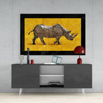 Rhino glass wall art styled above a console in a library