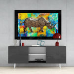 Colored Rhinoceros glass wall art styled above a console in a media room