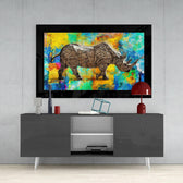 Colored Rhinoceros glass wall art styled above a console in a media room