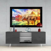 Elephant glass wall art styled above a console in a reading nook