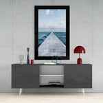 Far Horizon glass wall art styled above a console in a coastal cottage