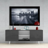 New York glass wall art styled above a console in a media room