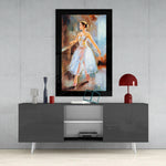 Ballerina glass wall art styled above a console in a reading nook