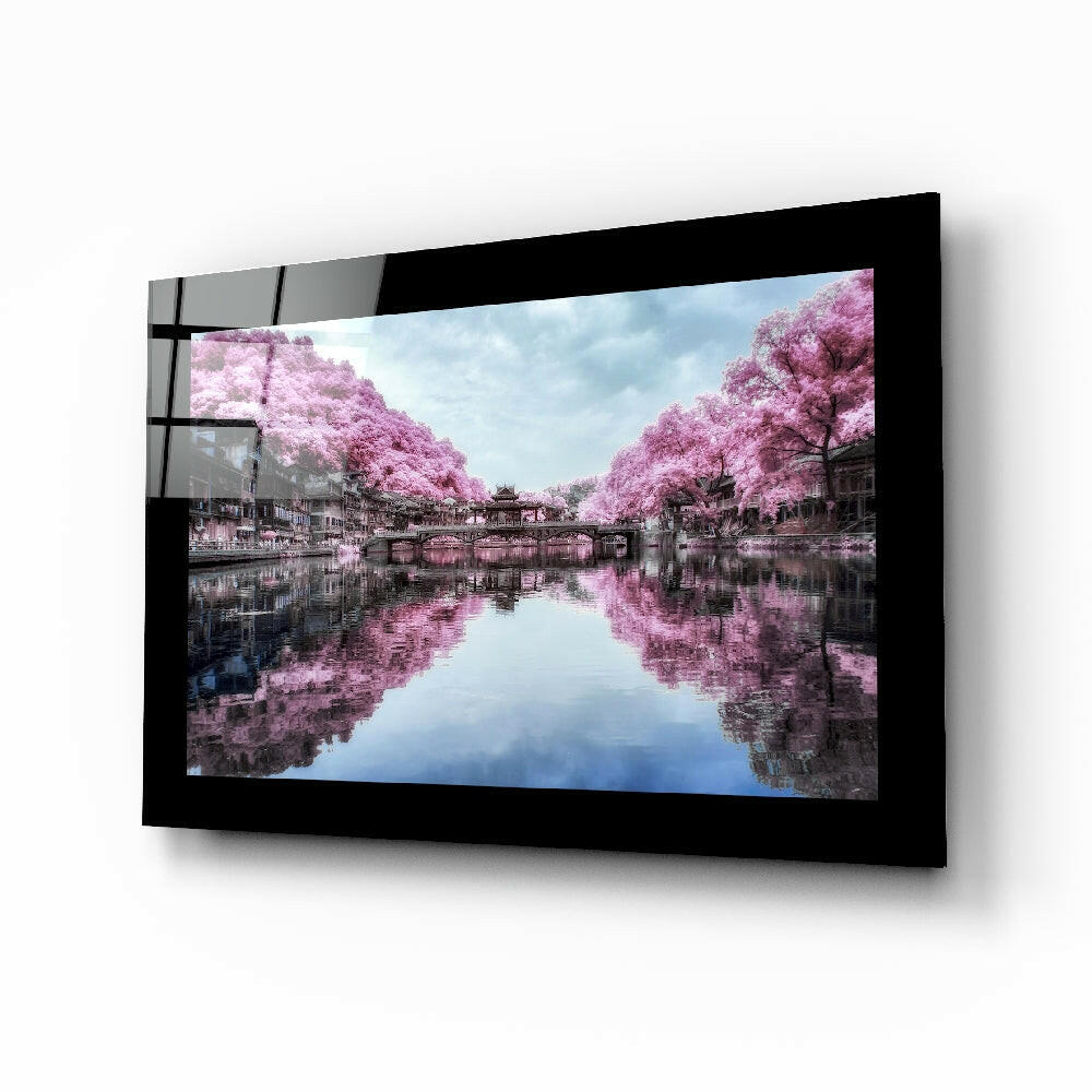 Sakura Trees glass wall art displayed above a bed in a bedroom