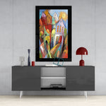 Houses glass wall art styled above a sideboard in a foyer