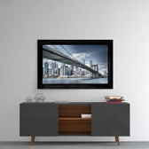 Brooklyn Bridge glass wall art styled above a console in a reading nook