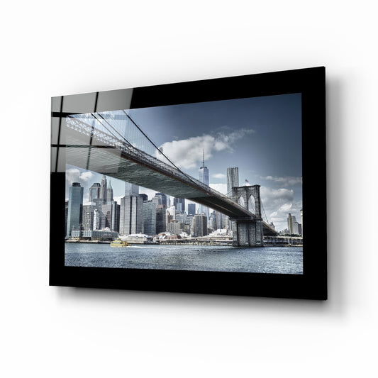 Brooklyn Bridge glass wall art displayed above a sideboard in a study