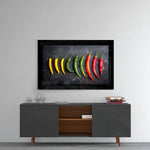 Peppers glass wall art styled above a console in a breakfast nook