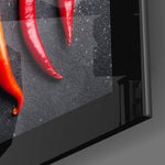 Peppers close-up showing yellow, green and red chilis on slate