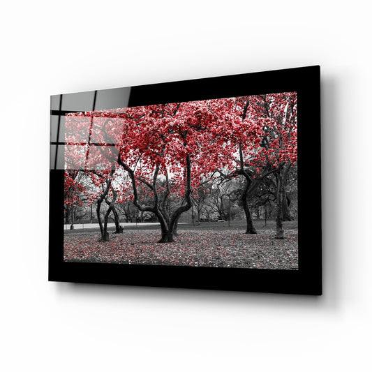 Red Trees glass wall art displayed above a sideboard in a study
