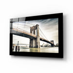 Brooklyn Bridge glass wall art displayed above a sideboard in a study
