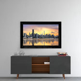 The City glass wall art styled above a console in a reading nook