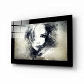 Woman glass wall art displayed above a bed in a bedroom