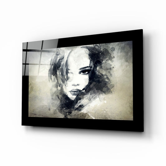 Woman glass wall art displayed above a bed in a bedroom