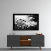 Bloom glass wall art styled above a console in a reading nook