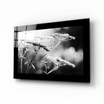 Bloom glass wall art displayed above a bed in a bedroom