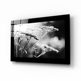 Bloom glass wall art displayed above a bed in a bedroom