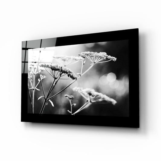 Bloom glass wall art displayed above a bed in a bedroom