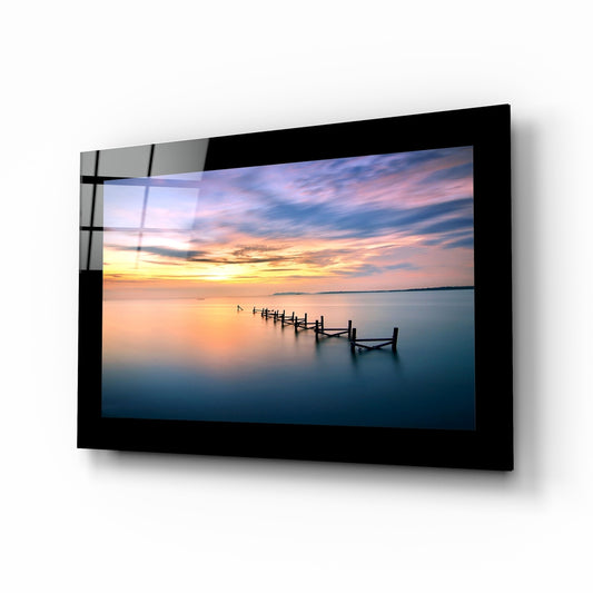 Sunset glass wall art displayed above a bed in a bedroom