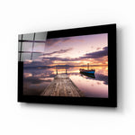 Sunset glass wall art displayed above a bed in a bedroom