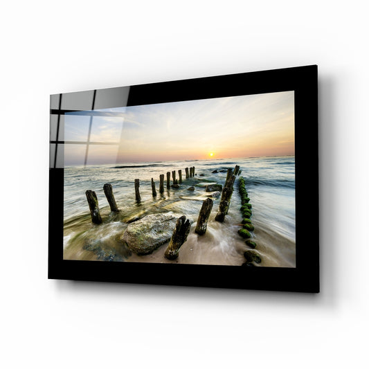 Sunset glass wall art displayed above a bed in a bedroom