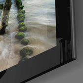 Sunset close-up showing weathered posts and silken surf
