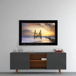 Sunset glass wall art styled above a console in a man cave
