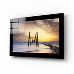 Sunset glass wall art displayed above a sideboard in a coastal cottage
