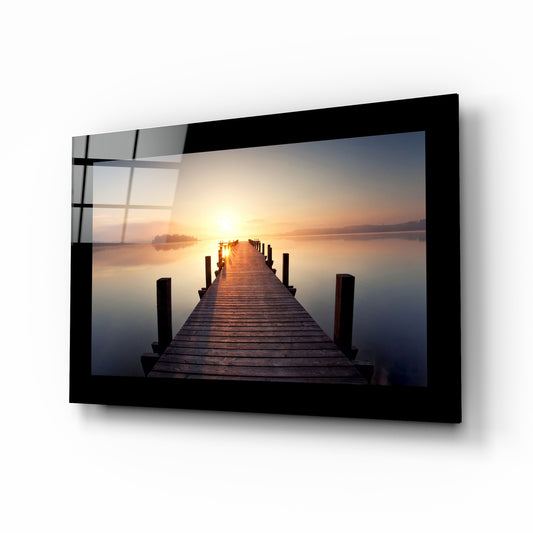 Sunset glass wall art displayed above a bed in a bedroom