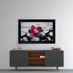 Orchid glass wall art styled above a console in a bedroom