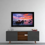 Sunset glass wall art styled above a console in a meditation room