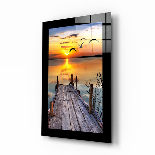 Sunset and the Birds glass wall art displayed above a bed in a bedroom