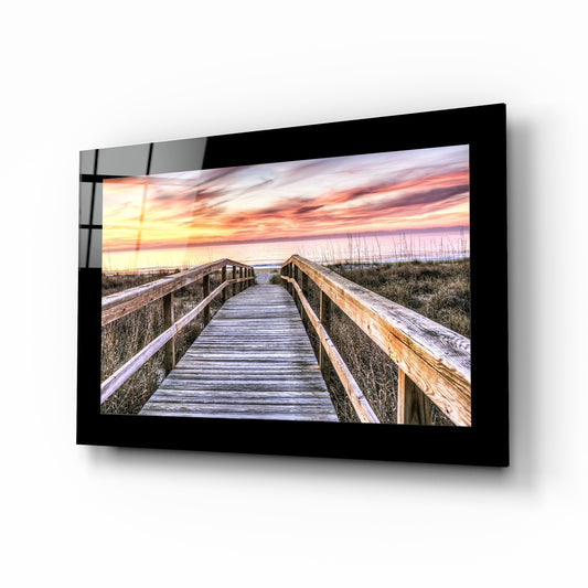 Sunset glass wall art displayed above a bed in a bedroom