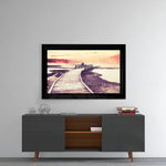 Sunset glass wall art styled above a console in a reading nook