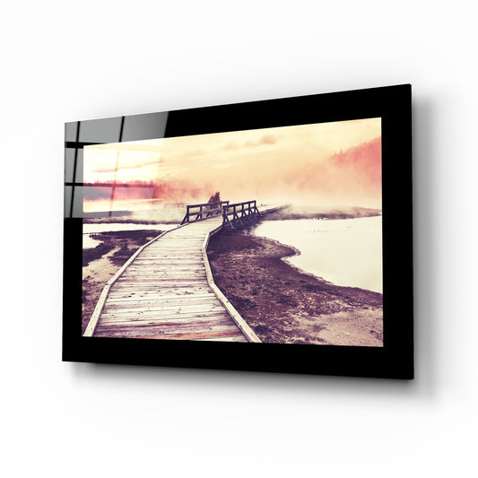 Sunset glass wall art displayed above a bed in a bedroom