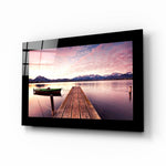 Sunset glass wall art displayed above a bed in a bedroom