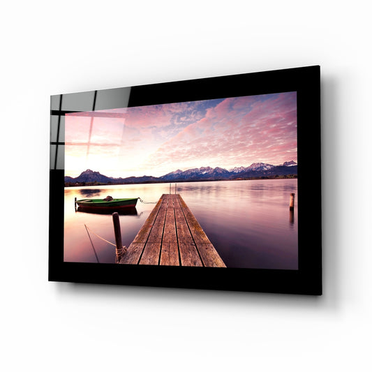 Sunset glass wall art displayed above a bed in a bedroom