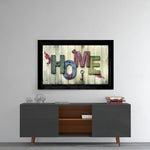 Home glass wall art styled above a sideboard in a reading nook