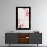 Pinky glass wall art styled above a console in a foyer