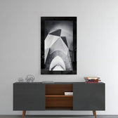 Gate glass wall art styled above a sideboard in a foyer