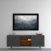 Forest glass wall art styled above a console in a reading nook